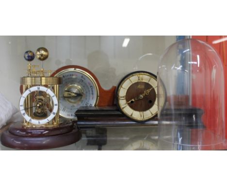A Frank Hermle Astrolabium 2000 celestial clock, under a glass dome, together with a Hermle mantle clock and an Aneroid barom