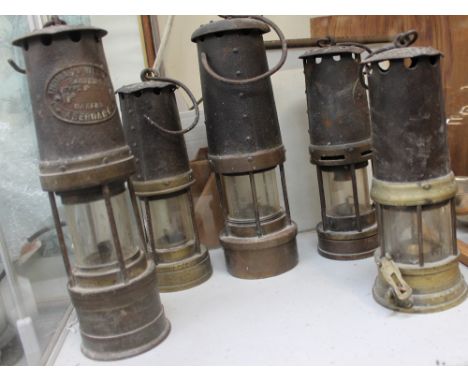A Thomas and Williams miner's lamp together with four other miner's lamps
