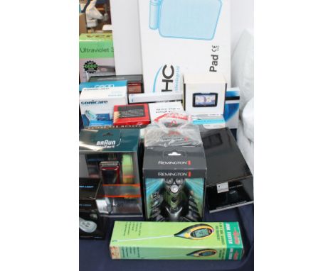 A collection of new and used boxed appliances  including a massage pad together with a computer keyboard, sat navs, cordless 