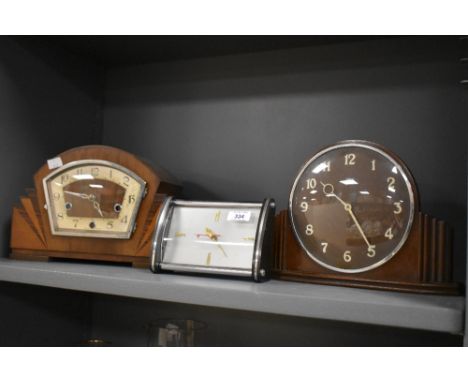 A 1940's walnut mantel clock of arched design with stepped sunburst elements and Arabic hours, sold together with an oak Meta