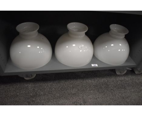 A group of three milk glass lamp shades, of hemispherical form with short flared top