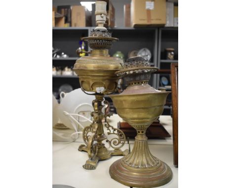 A 19th Century brass table lamp, converted from an oil lamp and measuring 52cm high, together with another brass oil lamp
wir