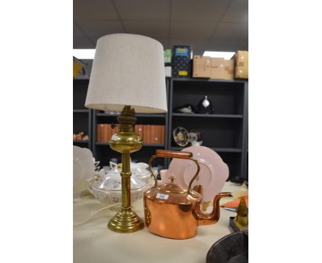 A 19th Century copper fireside kettle, measuring 27cm high, and a brass oil lamp form table lamp