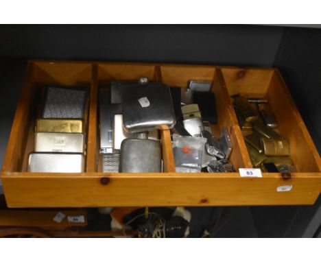 A pine four division tray containing various engraved metal cigarette and other boxes, hip flasks, and plus zippo and other l
