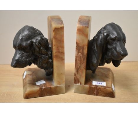A pair of Art Deco bookends, modelled as spelter spaniel dog heads signed 'Lecourtier' on angled variegated marble bases, eac