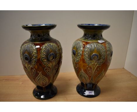 A pair of late 19th Century Doulton Lambeth pottery vases, decorated with a stylised Art Nouveau design and having circular a