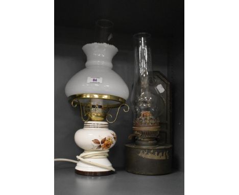 A mid-20th Century electrified table lamp in the form of an oil lamp, measuring 40cm high, and a tin wall mounted oil lamp