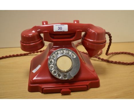 An early 20th Century red bakelite rotary dial telephoneCondition report - There are some minor nicks to the handset, with a 