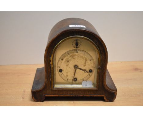 An early 20th century oak cased and arched chiming mantel clock, with Arabic hours