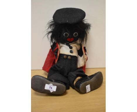 An early 20th Century soft bodied golly doll, with stitched facial features and wearing beefeater style outfit
Stained and gr