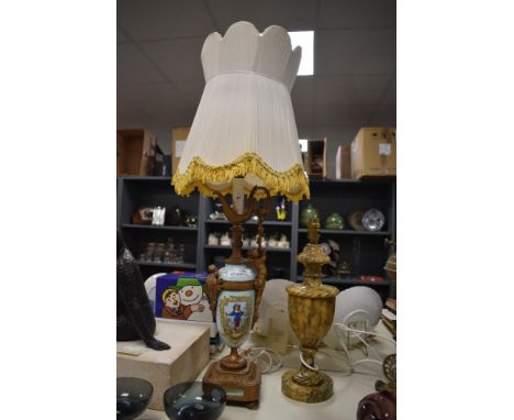 A 19th Century French porcelain table lamp, decorated with hand painted figural vignettes with gilt metal mounts, measuring 8
