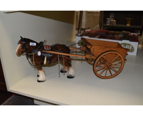 A vintage porcelain shire horse and cart ornament, measuring 65cm long overall