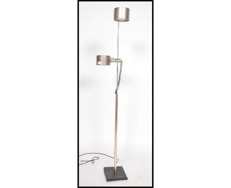 A retro mid century vintage twin spot floor standing polished steel lamp having a square base with central upright support an