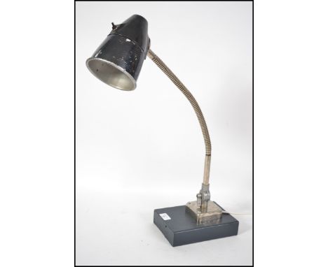 A vintage mid 20th century Russian made chromed goose-neck table / work lamp having a circular base with fitted conical shade