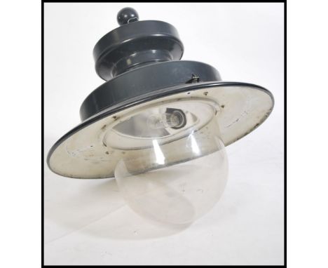 A vintage style 20th century industrial street lamp by Urbis. The cast metal pendant shade sitting above a large glass dome c