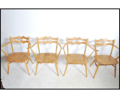 A set of four retro rare Ercol 493 Windsor Carver Chairs. Only in production for three years from 1964-1967, chairs construct