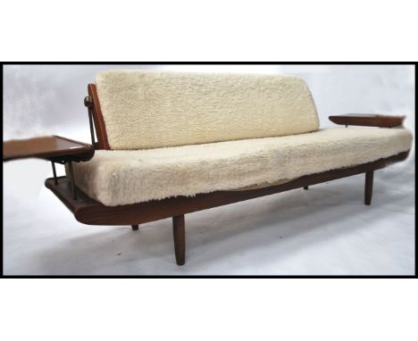 A stunning mid century teak and wool upholstered sofa daybed. by British Manufacturer Toothill of London. The sofa upholstere