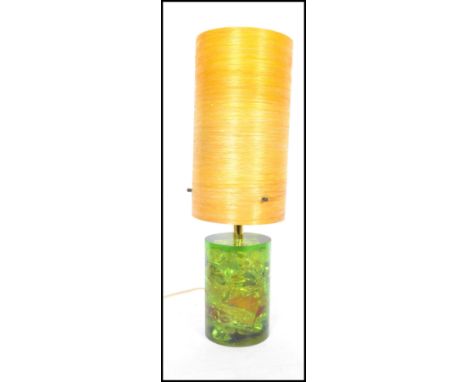 A retro vintage mid century Shatterline green type resin lamp base in orange having a spun cylindrical fibre glass shade atop