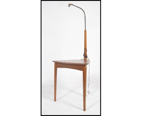 A 1960's / mid century retro teak wood standard lamp / side table combination being raised on turned angular legs having a tr