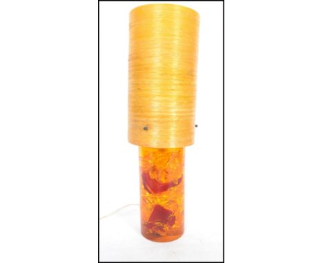 A retro vintage mid century Shatterline amber type resin lamp base in orange having a spun cylindrical fibre glass shade atop