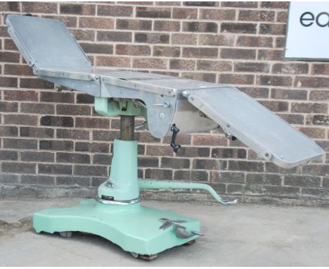 A good mid century Industrial / medical x-ray examination table having multiple folding steel adjustable bed with cushions ra