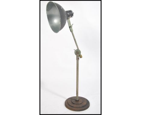 An Industrial mid century anglepoise cast metal desk lamp with terraced base and ufo saucer half moon shade having adjustable