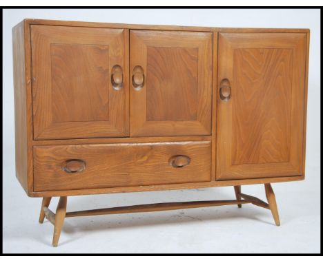 A good mid century Ercol Windsor pattern sideboard dresser. Of low form in beech and elm wood having central bank of drawers 