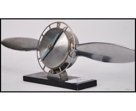 A 1930's Art Deco aluminium and marble propeller mantel clock. The apprentice piece designed clock with Jaeger style dial and