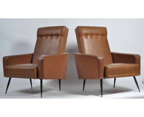 A good pair of 1950's mid century retro patch vinyl and button backed Pan-Am style armchairs of angular form raised on ebonis