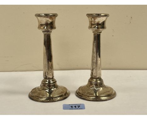 A pair of George V silver candlesticks. London 1922. 6' high. Loaded, dents