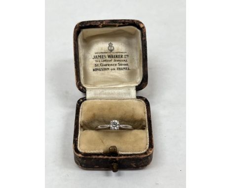 A diamond solitaire ring. In white gold marked 750. The brilliant cut stone 4mm diam approx. 3g gross. Size M