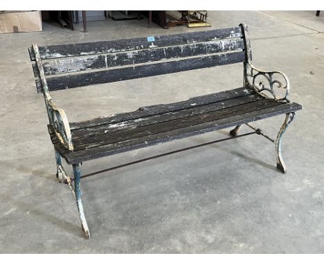 A cast iron and wood slatted garden bench. 47' wide