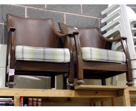 Pair of mid century wooden, leather bound arm chairs with light tartan cushions. Not available for in-house P&amp;P 