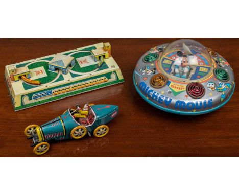 A mid to late 20th century Mickey Mouse spaceship, made in Japan, with TM logo beneath and with a battery compartment, 20cm d