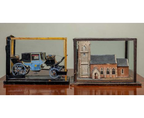 An old scale model of a blue painted carriage, 30cm long; together with an old scale model of a parish church, 26cm longBoth 