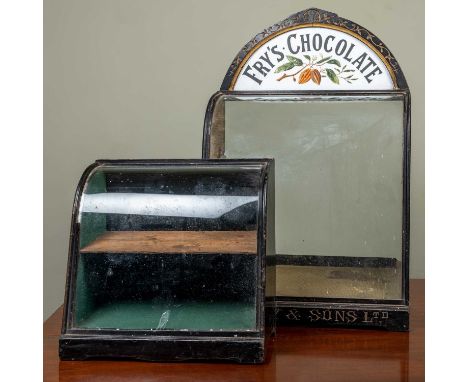 A 19th century Fry's Chocolate countertop display cabinet with painted white glass inset panelled arching top, a shaped glass