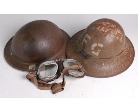 A WW II Zuckerman Fire Guard steel helmet, together with one other WW II Brodie pattern helmet, a pair of Stadium flying/moto