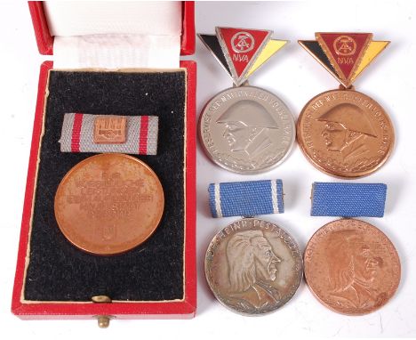 A GDR Border Force medal in a fitted leather case, together with National Peoples Army Reservist medal x2 and East German Pes