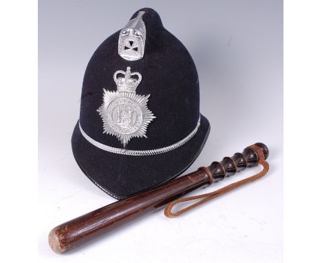 A turned wooden policeman's truncheon, together with a modern Suffolk Constabulary police helmet and two modern fire helmets.