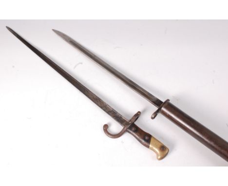 A French M1874 Gras bayonet, having a 52cm blade with hooked quillon stamped 35124 and brass mounted two piece grip, in a ste