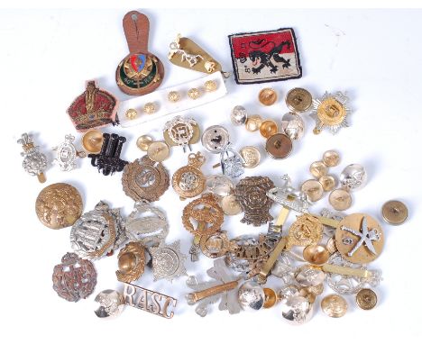 A collection of assorted cap badges, cloth badges, buttons and insignia to include Royal Army Service Corps, Royal Hussars an