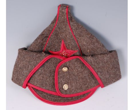 A Soviet Red Army Budenovka, having a stitched red star with enamelled badge and folding side flaps.