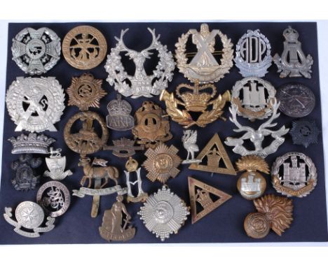 A collection of assorted military cap badges and insignia to include Border Regiment, Indian Army Ordinance Corps, London Sco