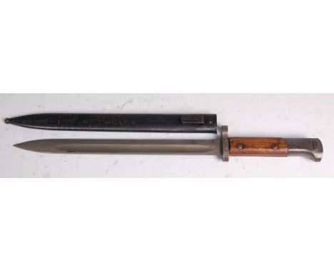 A Czechoslovakian Model 33/40 bayonet, having a 30cm single edged fullered blade and two piece grip, in a steel sheath, 44.5c