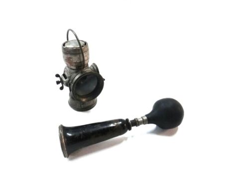 An early 20th century brass cased 'Lucas King of the Road' three inch automobile light, together with a 'Lesmo' horn. (2)