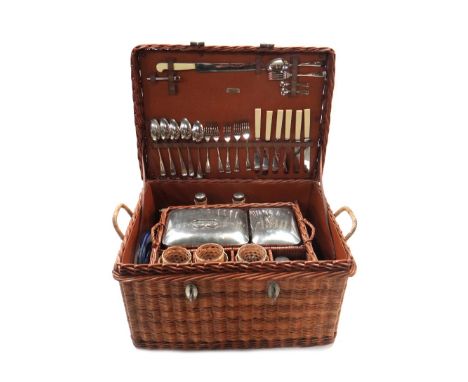 A mid 20th century automobile picnic set, contained in a wicker basket, 56cm wide x 41cm deep.