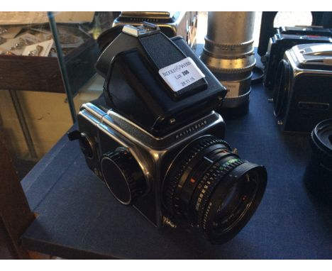A Hasselblad camera with Carl Zeiss Planar 1:2,8 80mm lens.