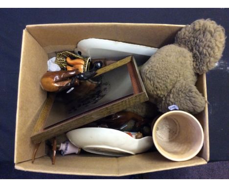 A box of various household items including a teddy bear, a ceramic vase and dish and a set of wooden animals.