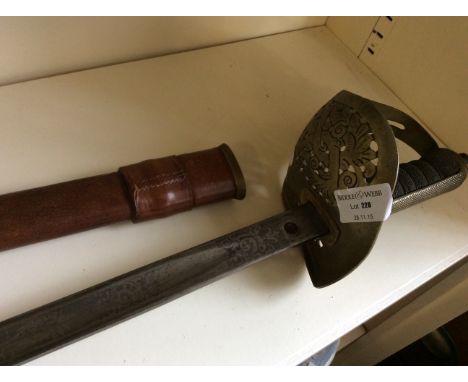 An early 20th Century sword with basket hilt in leather bound scabbard.