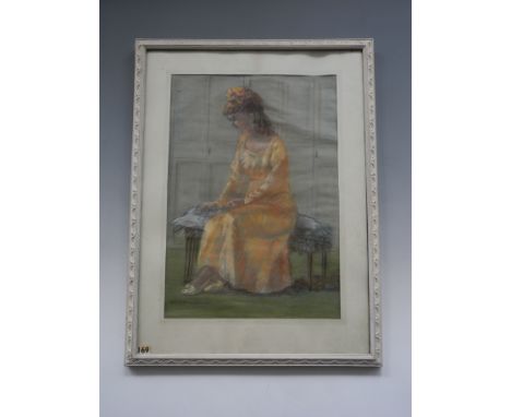 D M HIGINBOTTOM. Framed, glazed, signed, 20th Century, pastel on paper, portrait of a young woman in peach seated on a low st